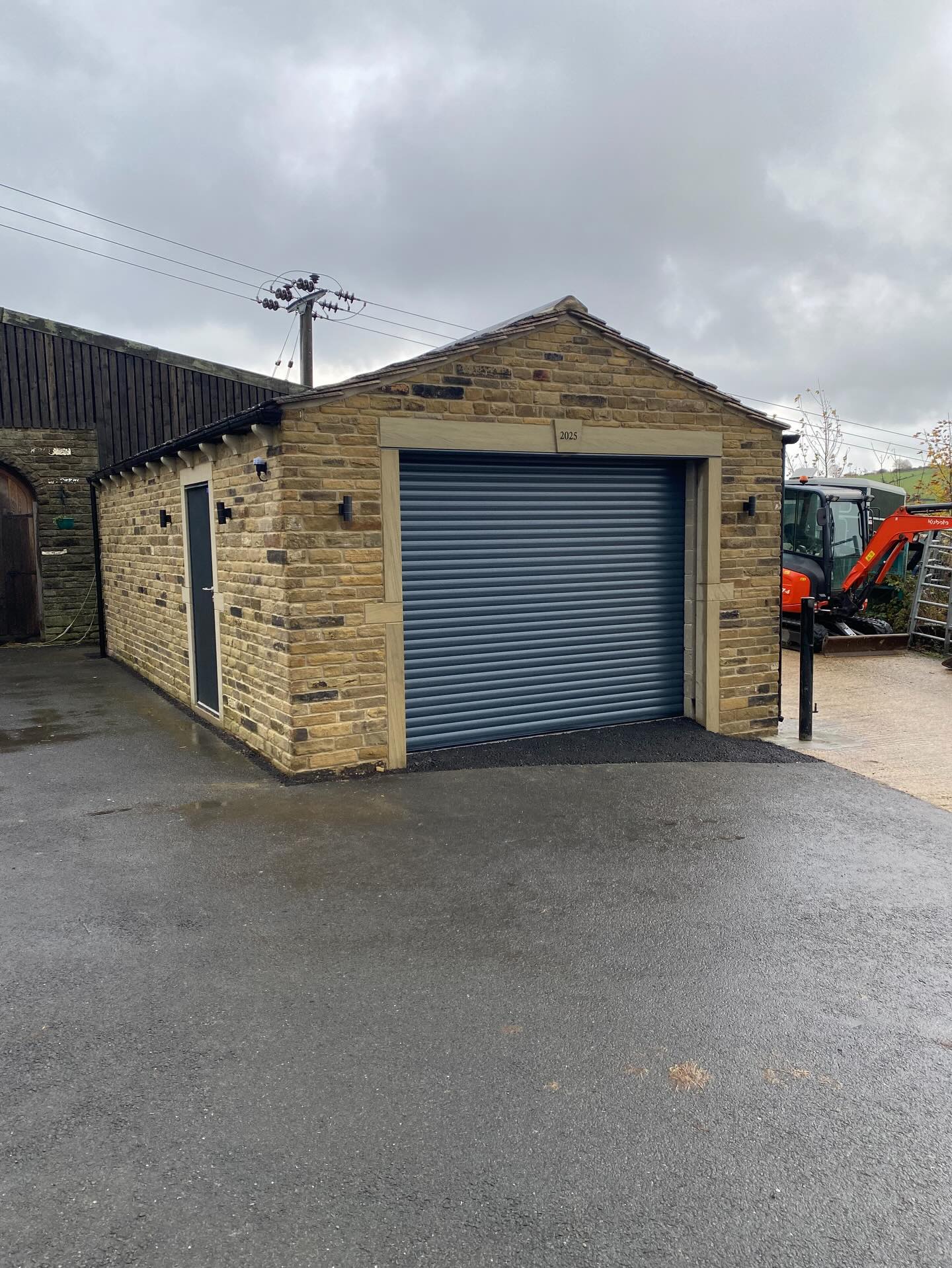 Stone garage with roller shutter door